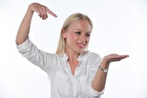 woman pointing on imaginary object. Isolated on white background photo