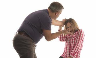 domestic violence, abuse and people concept - man beating helpless woman at home photo