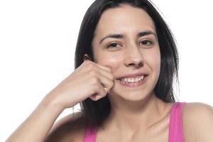 A woman who pinches the fat on her jaw. photo