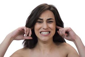 Annoyed stressed woman cover ears feel hurt ear ache pain otitis suffer from loud noise sound headache, irritated stubborn girl deaf hear not listen to noisy music isolated on white studio background photo