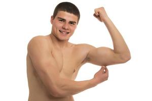 A fit young man pinching body fat on his body photo