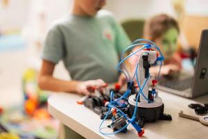 Children learning repairing getting lesson control robot arm, robotic machine arm in home workshop, technology future science education. photo