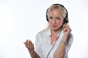 Remote consultant. Confident millennial female client support assistant sit at workplace by laptop wear headset consult caller. photo