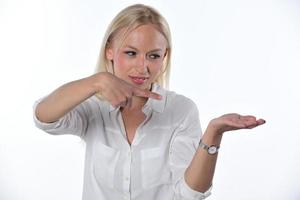 woman pointing on imaginary object. Isolated on white background photo