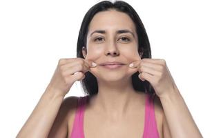 A woman who pinches the fat on her jaw. photo