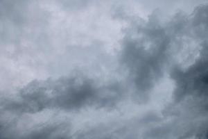 Storm clouds floating in a rainy day with natural light. Cloudscape scenery, overcast weather above blue sky. White and grey clouds scenic nature environment background photo