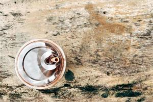 Top view of ice chocolate milk in a clear plastic glass on a wooden table photo