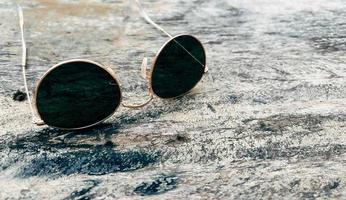 Sunglasses on wooden table summer concept background photo