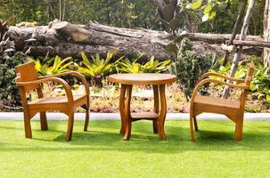 Outdoor wooden chair and table at lawn coffee shop photo