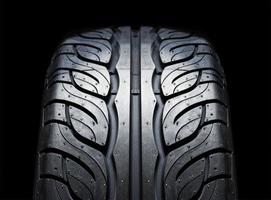 On-road tire tread isolated on black background photo