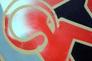 Street art. Abstract background image of a fragment of a colored graffiti painting in red tones photo