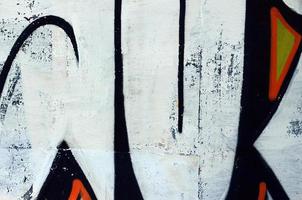 Street art. Abstract background image of a fragment of a colored graffiti painting in white and orange tones photo