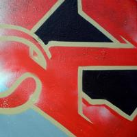 Street art. Abstract background image of a fragment of a colored graffiti painting in red tones photo