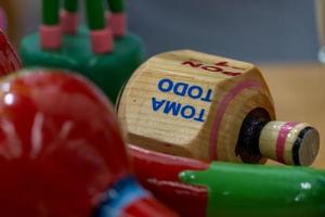 Traditional pirinola mexican handmade wooden toy with titles in spanish take all, put one, put two photo