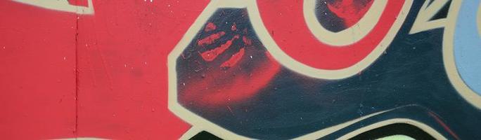 Street art. Abstract background image of a fragment of a colored graffiti painting in red tones photo