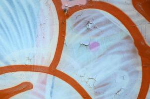 Street art. Abstract background image of a fragment of a colored graffiti painting in white and orange tones photo