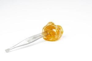 cannabis gold live resin on dab stick with high thc isolated on white background photo