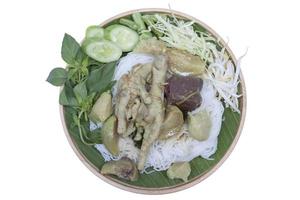 Top view of Rice Vermicelli with Green Curry Chicken and vegetable in wooden plate isolated on white background included clipping path. photo