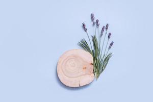 Wooden podium, stage or pedestal with lavender flowers top view. Mock up for cosmetic products photo