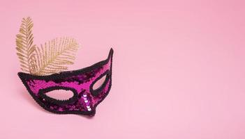 Festive face masquerade mask for carnival celebration on colored background with copy space photo