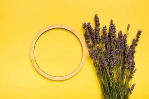 Lavender flowers on colored background top view. Copy space in round frame photo