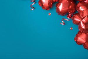 Valentines Day blank greeting card. Copy space. Red heart shape balloons on turquoise background. photo