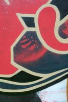 Street art. Abstract background image of a fragment of a colored graffiti painting in red tones photo