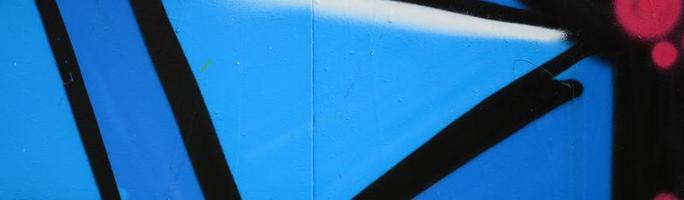 Street art. Abstract background image of a fragment of a colored graffiti painting in blue tones photo