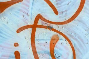 Street art. Abstract background image of a fragment of a colored graffiti painting in white and orange tones photo