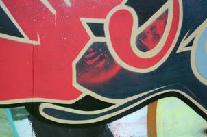 Street art. Abstract background image of a fragment of a colored graffiti painting in red tones photo