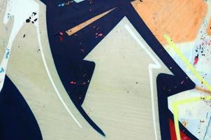 Street art. Abstract background image of a fragment of a colored graffiti painting in white and orange tones photo