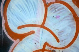 Street art. Abstract background image of a fragment of a colored graffiti painting in white and orange tones photo