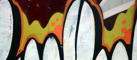 Street art. Abstract background image of a fragment of a colored graffiti painting in white and orange tones photo