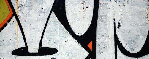 Street art. Abstract background image of a fragment of a colored graffiti painting in white and orange tones photo