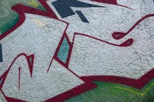 Street art. Abstract background image of a fragment of a colored graffiti painting in chrome and red tones photo