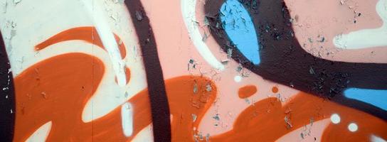 Street art. Abstract background image of a fragment of a colored graffiti painting in beige and orange tones photo