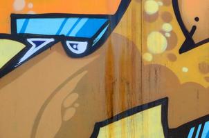 Street art. Abstract background image of a fragment of a colored graffiti painting in beige and orange tones photo