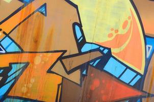 Street art. Abstract background image of a fragment of a colored graffiti painting in beige and orange tones photo