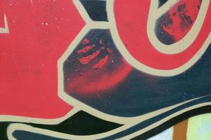 Street art. Abstract background image of a fragment of a colored graffiti painting in red tones photo