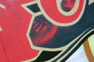 Street art. Abstract background image of a fragment of a colored graffiti painting in red tones photo