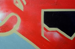 Street art. Abstract background image of a fragment of a colored graffiti painting in red tones photo