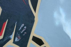 Street art. Abstract background image of a fragment of a colored graffiti painting in dark grey and red tones photo