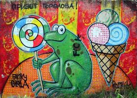 Street art. Abstract background image of a full completed graffiti painting with cartoon frog and lollipop photo