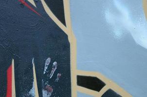 Street art. Abstract background image of a fragment of a colored graffiti painting in dark grey and red tones photo