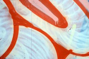 Street art. Abstract background image of a fragment of a colored graffiti painting in white and orange tones photo