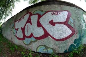 Street art. Abstract background image of a full completed graffiti painting in chrome fill, green background and red outlines. Fisheye photo