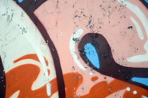 Street art. Abstract background image of a fragment of a colored graffiti painting in beige and orange tones photo