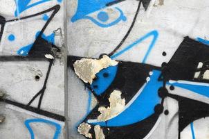 Street art. Abstract background image of a fragment of a colored graffiti painting in chrome and blue tones photo