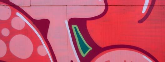 Street art. Abstract background image of a fragment of a colored graffiti painting in red tones photo