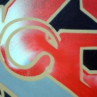 Street art. Abstract background image of a fragment of a colored graffiti painting in red tones photo